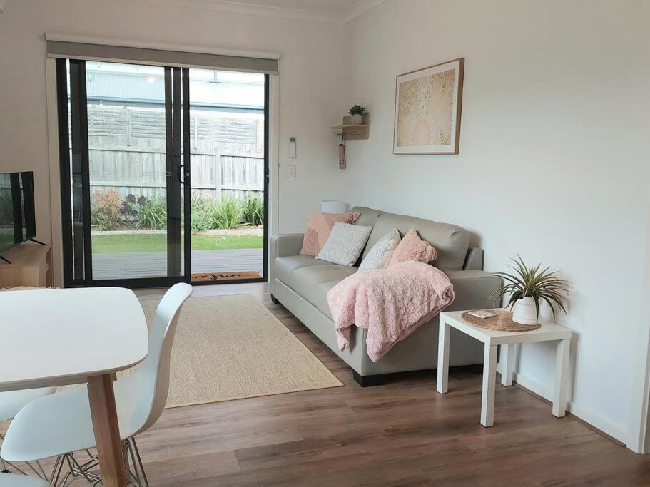 a living room with a couch and a table at Lake and Railway Guesthouse in Drysdale