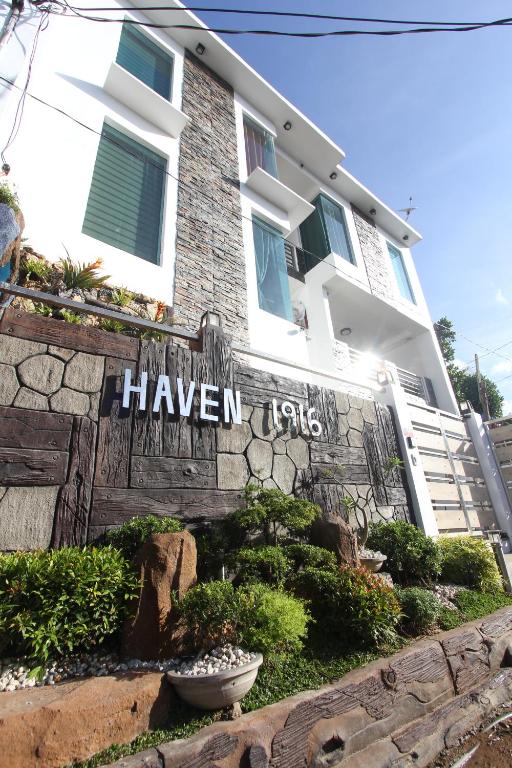 a building with a sign that sayshaven uses at Haven 1916 Pension House in Coron
