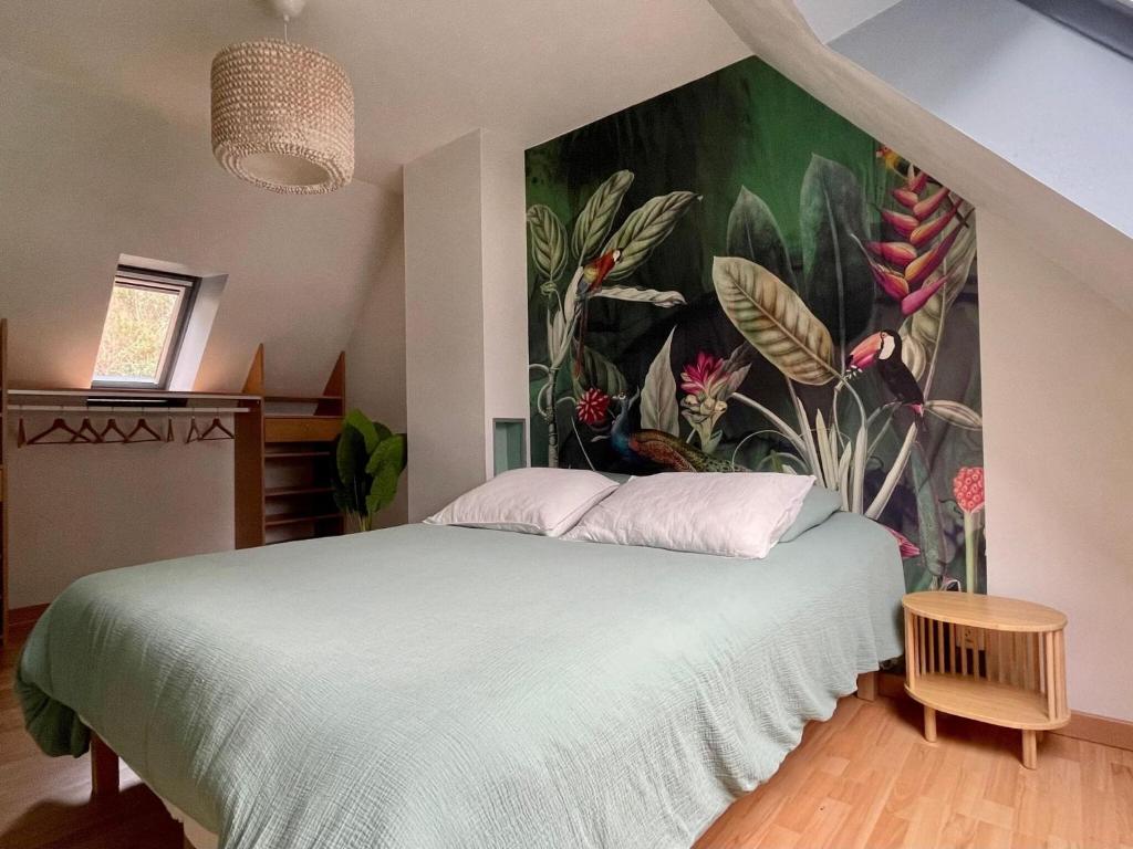 a bedroom with a large bed with a painting on the wall at Premium holiday home in top location with sea view, Plougasnou in Plougasnou