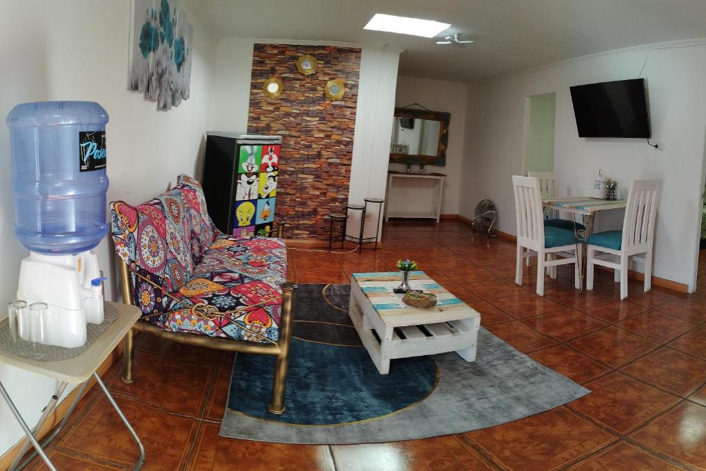 a living room with a couch and a table at MatSofy_Apartamento in Santiago