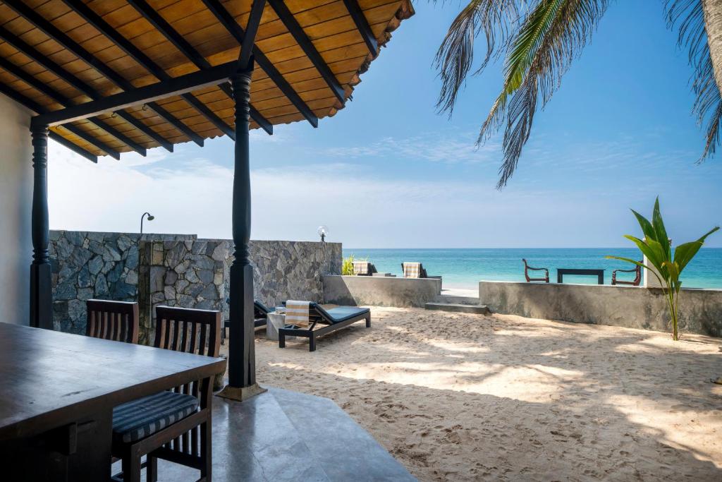 a view of the beach from the patio of a resort at Blue Parrot Beach Villa in Ambalangoda