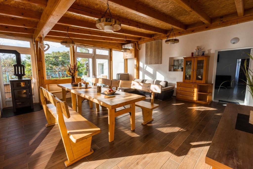 a living room with a wooden table and chairs at Apartmaji Natura KOLPA in Adlešiči