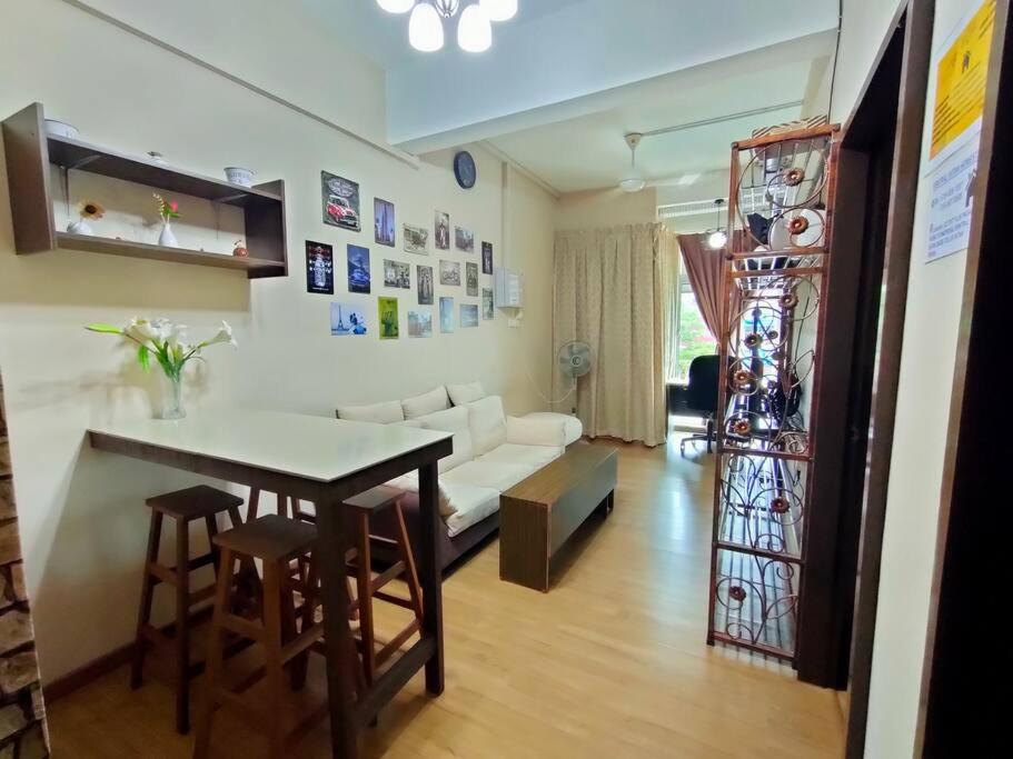 a living room with a table and a white couch at 1 MINUTES TO TOWER SENTRAL INTAN HOMESTAY 6 ROOMS in Teluk Intan