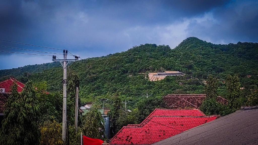a view of a mountain with a red roof at MOANA INN in Karimunjawa