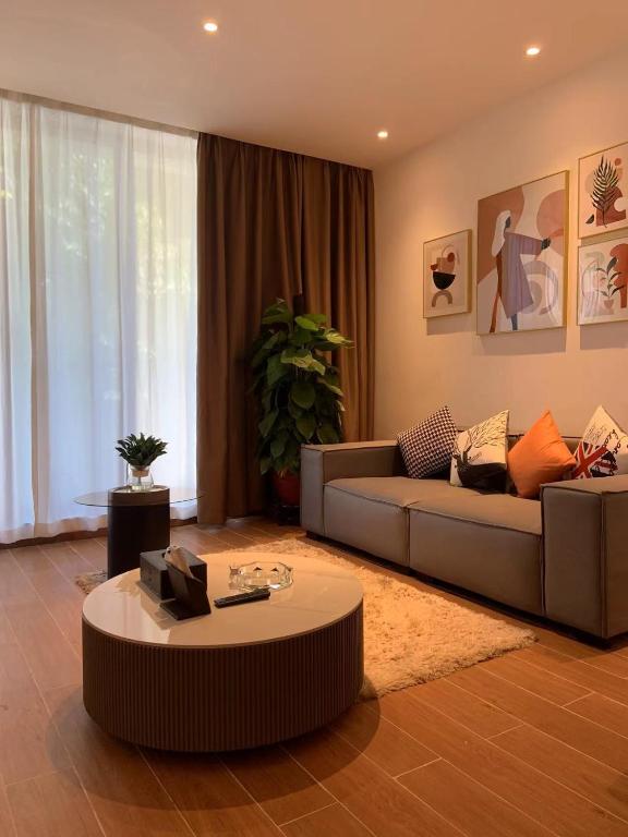 a living room with a couch and a coffee table at Guangzhou Fangyuan Hotel - Free Shuttle Bus to Canton Fair Complex during 14th Oct to 3rd Nov in Guangzhou