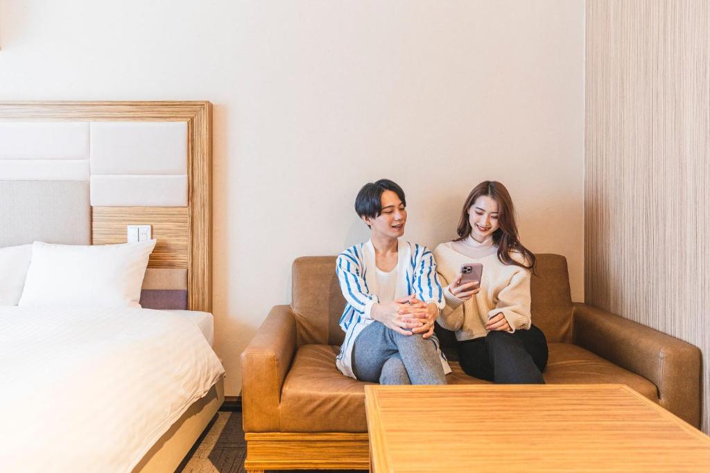 Postel nebo postele na pokoji v ubytování HOTEL RELIEF Namba Daikokuchou