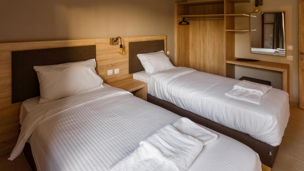Postel nebo postele na pokoji v ubytování Goudelis Apartments