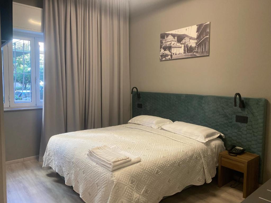 een slaapkamer met een bed met twee handdoeken erop bij Hotel Graziella in Arma di Taggia