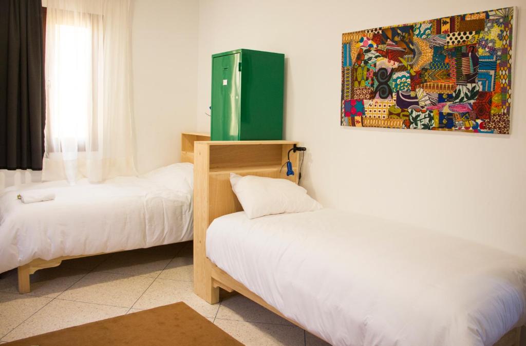 Postel nebo postele na pokoji v ubytování La Maison Jaune Dakhla Maison d'hôtes