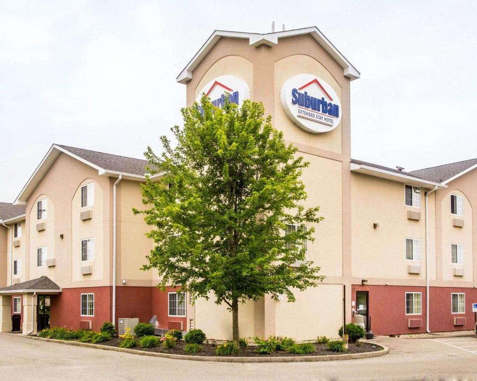 a hotel with a tree in front of it at Suburban Studios Dayton-WP AFB in Beavercreek