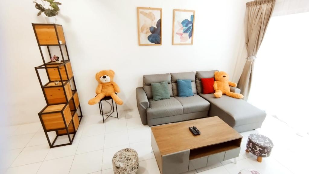 a living room with a couch and two teddy bears at The Quintet Condominium 3-1 in Tanah Rata