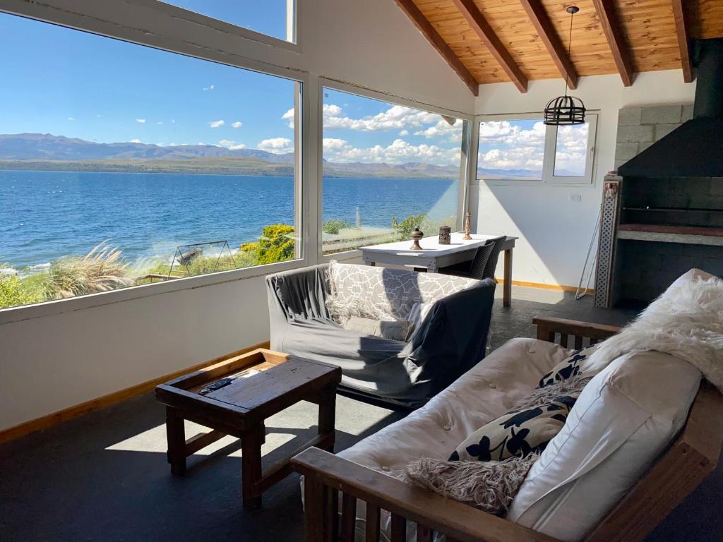 a living room with a view of the water at Lake in San Carlos de Bariloche