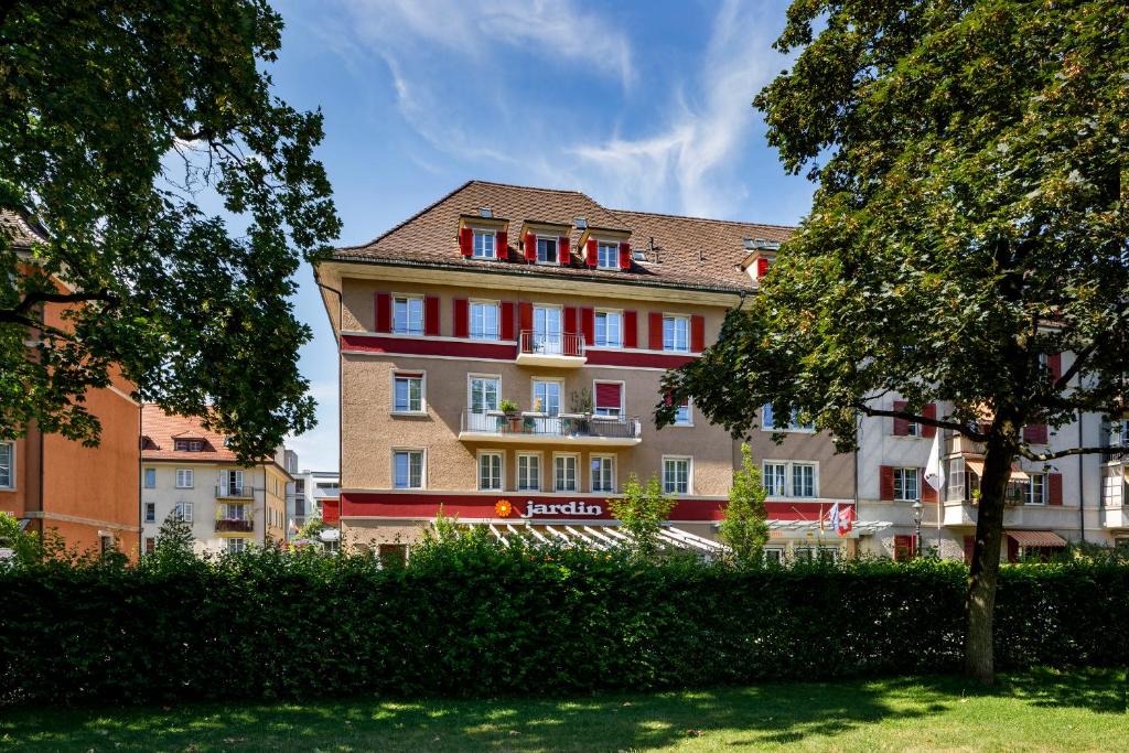 a large building with red and white windows at Hotel Jardin Bern in Bern