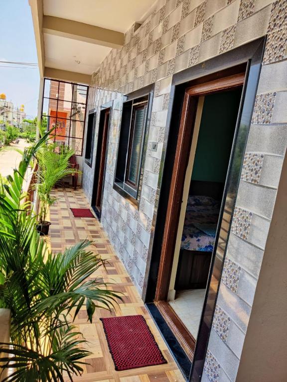a house with a balcony with a door at Balaji Homestay in Hampi