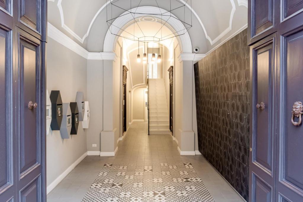 a hallway with blue doors and a tile floor at Donna Teresa Central & Cozy Apartment in Taranto