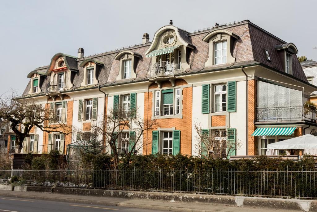 a large house on the side of a street at Luxury Apartments Justingerweg Bern in Bern