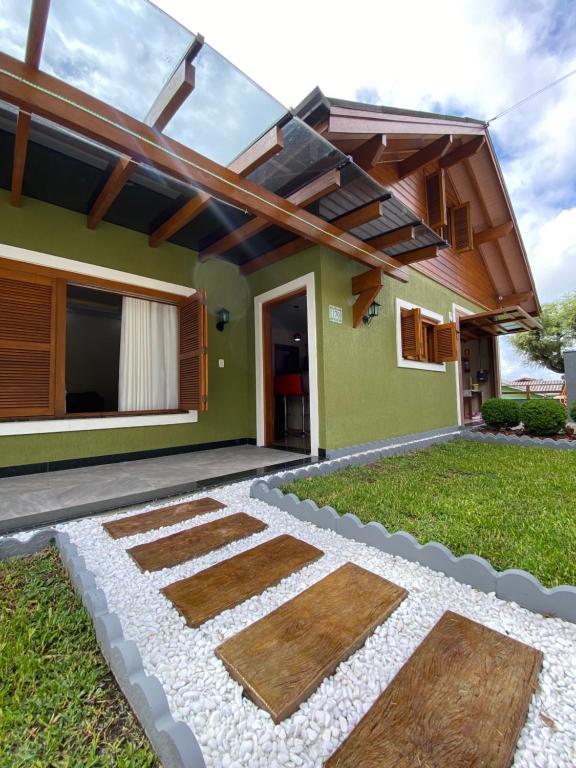 a house with a garden in front of it at Casa Petri Gramado in Gramado