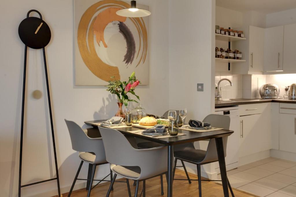 a dining room with a table and chairs at Central London - The Shoreditch, Angel, Old Street Apartment in London