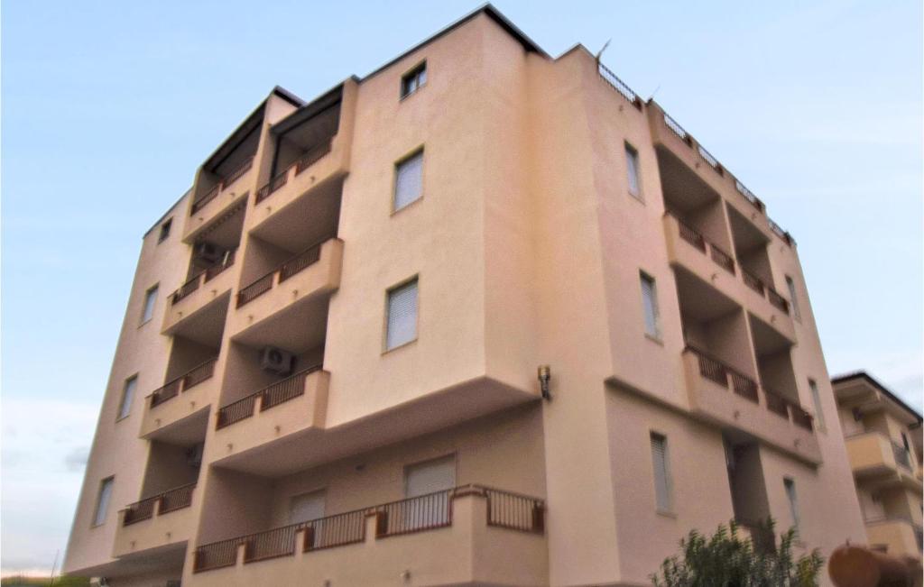 a tall building with balconies on the side of it at Lovely Apartment In Marina Di Strongoli With House Sea View in Marina di Strongoli