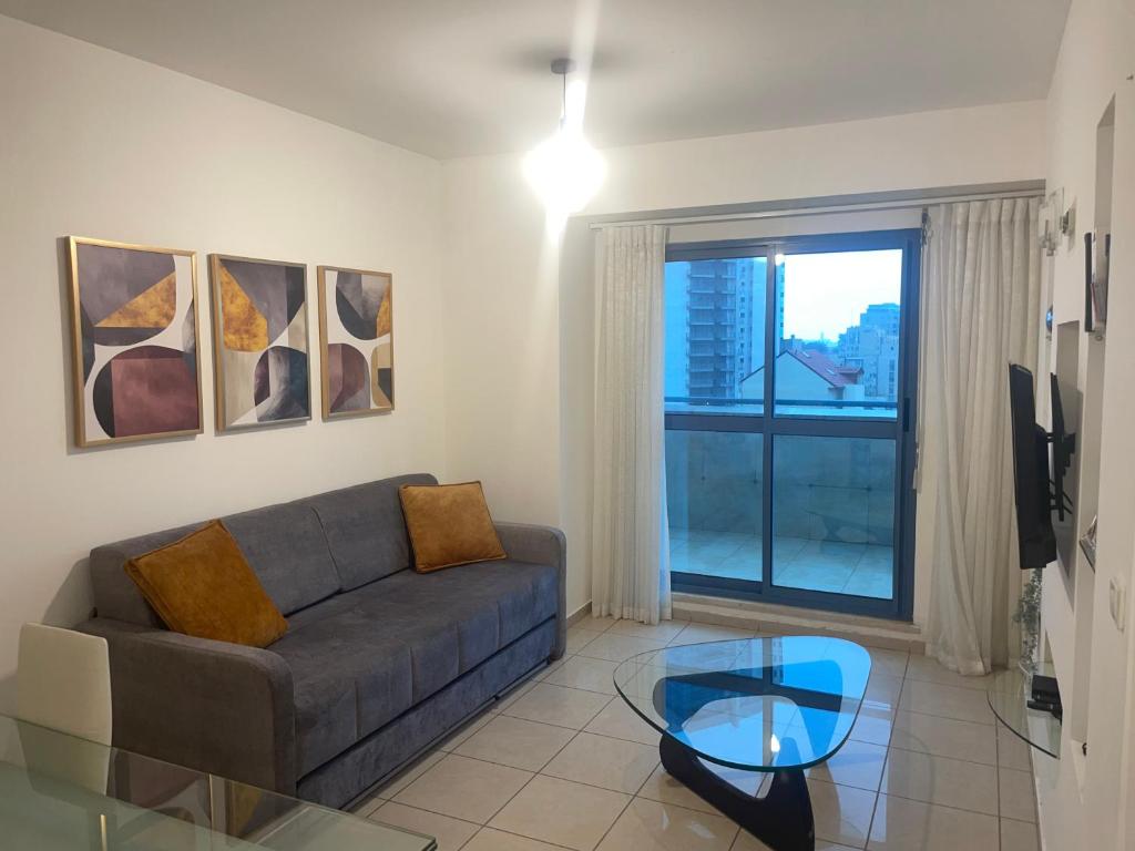 a living room with a couch and a glass table at Beautiful apartment in center of Jerusalem in Jerusalem