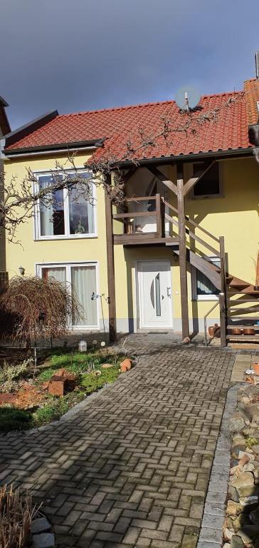 a house with a bench in front of it at Ferienwohnung Teufelsmauer in Timmenrode