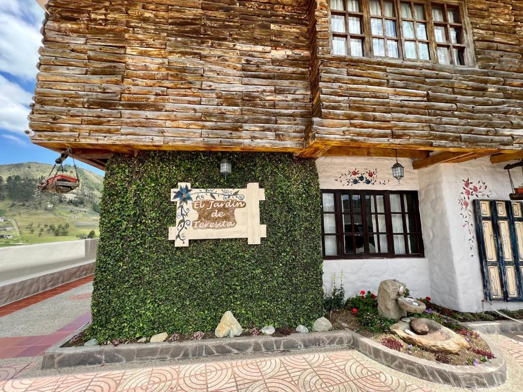 a building with a sign on the side of it at Estancia Jardín de Teresita 