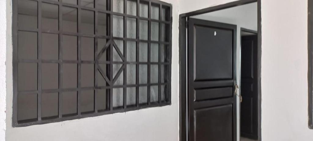 a black door and a mirror on a wall at Apartamentos Mage in Cerro el Bita