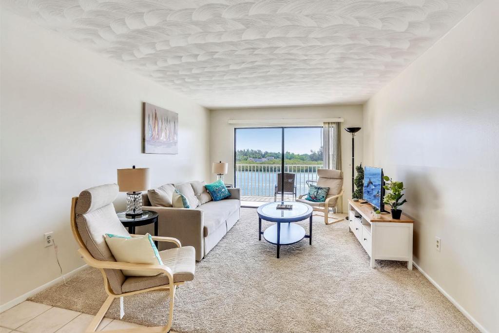 a living room with a couch and a table at Bayshore Yacht & Tennis 314 in Clearwater Beach
