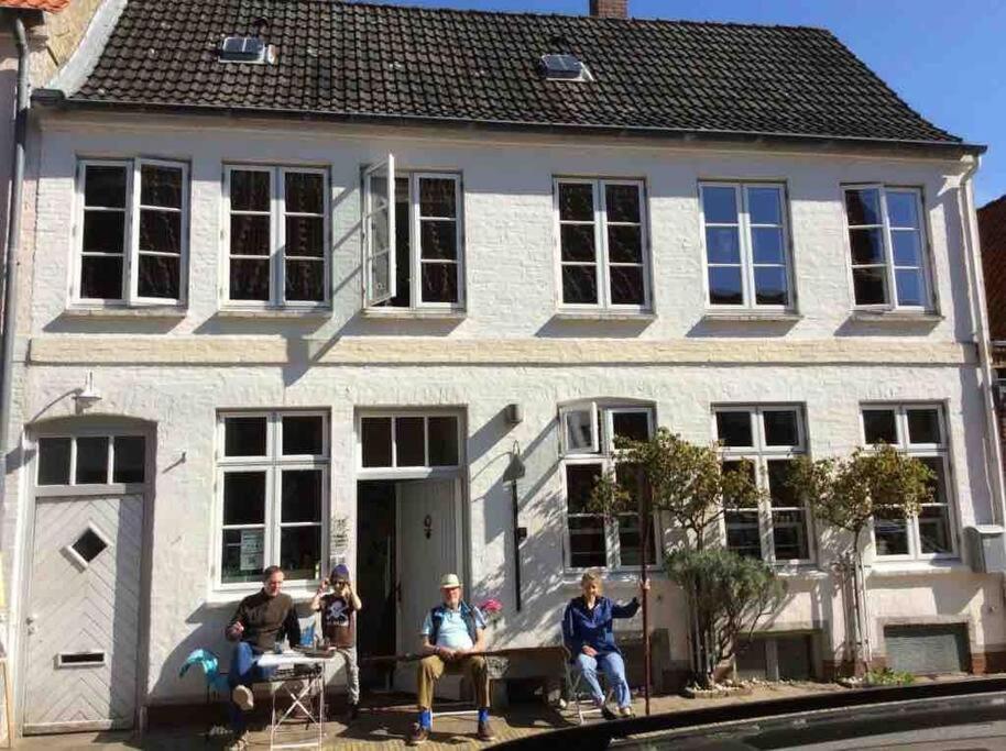 a group of people sitting in front of a house at westcoast-Speicher in Friedrichstadt