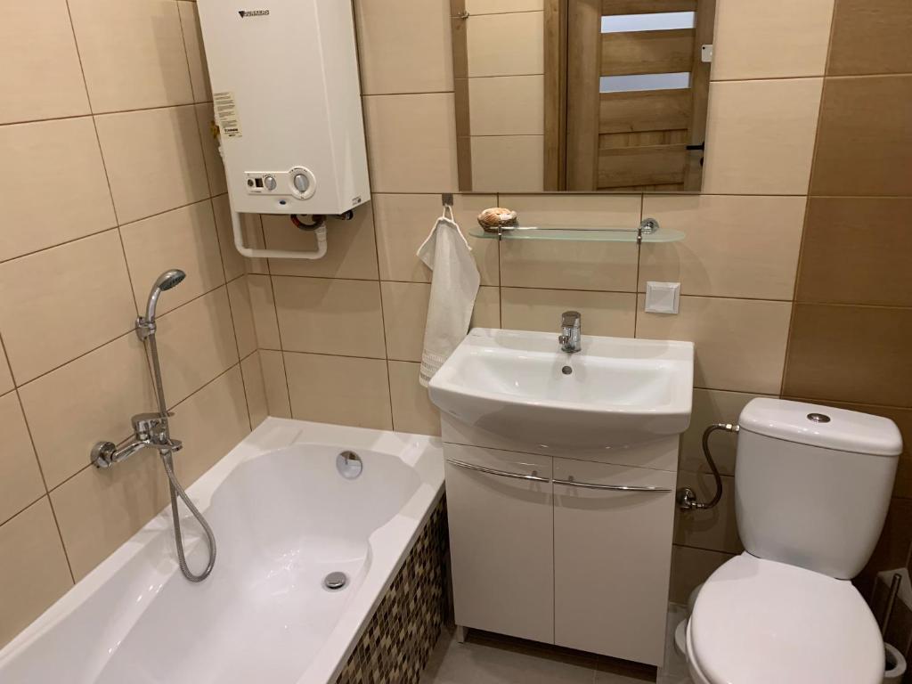 a bathroom with a toilet and a sink at Apartament Second Home in Strzelce Opolskie