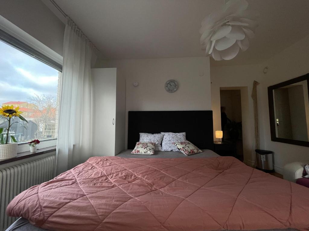 a bedroom with a large bed with a large window at Brabo2 in Landskrona