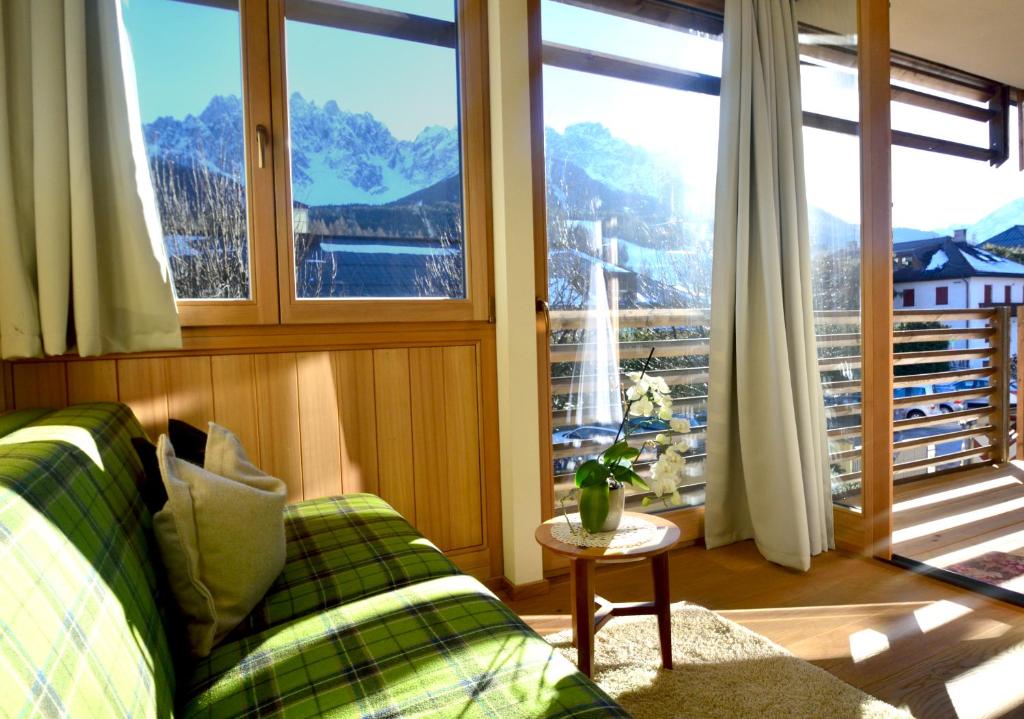 a living room with a couch and a large window at Residence Intica in San Candido