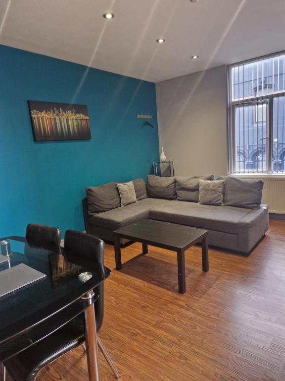 a living room with a couch and a table at Central Northern Quarter Apartment Sleeps Upto 4 in Manchester
