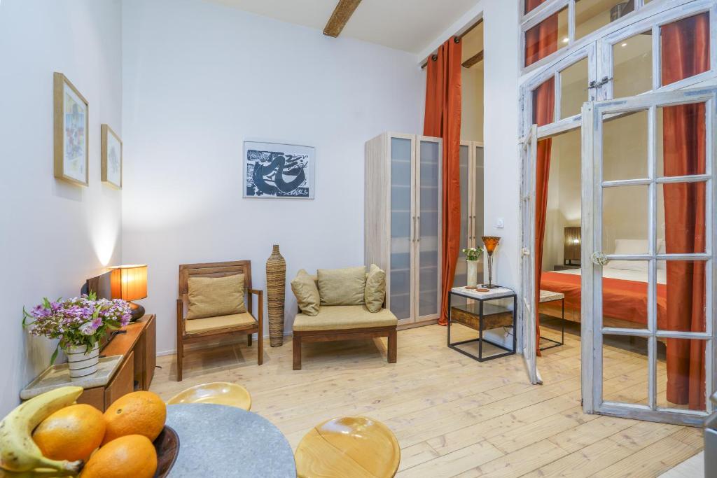 een woonkamer met een kamer met een bed en een tafel bij LA MAISON VERTE SETE in Sète