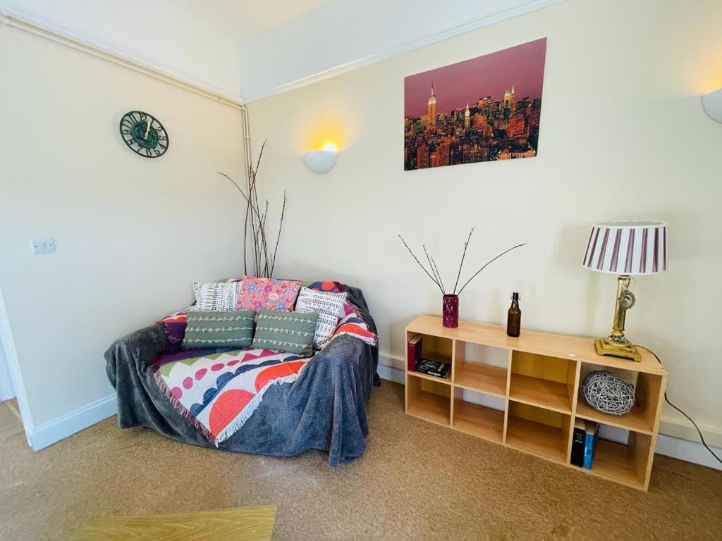 a bedroom with a bed and a table with a lamp at 22B in Wellingborough