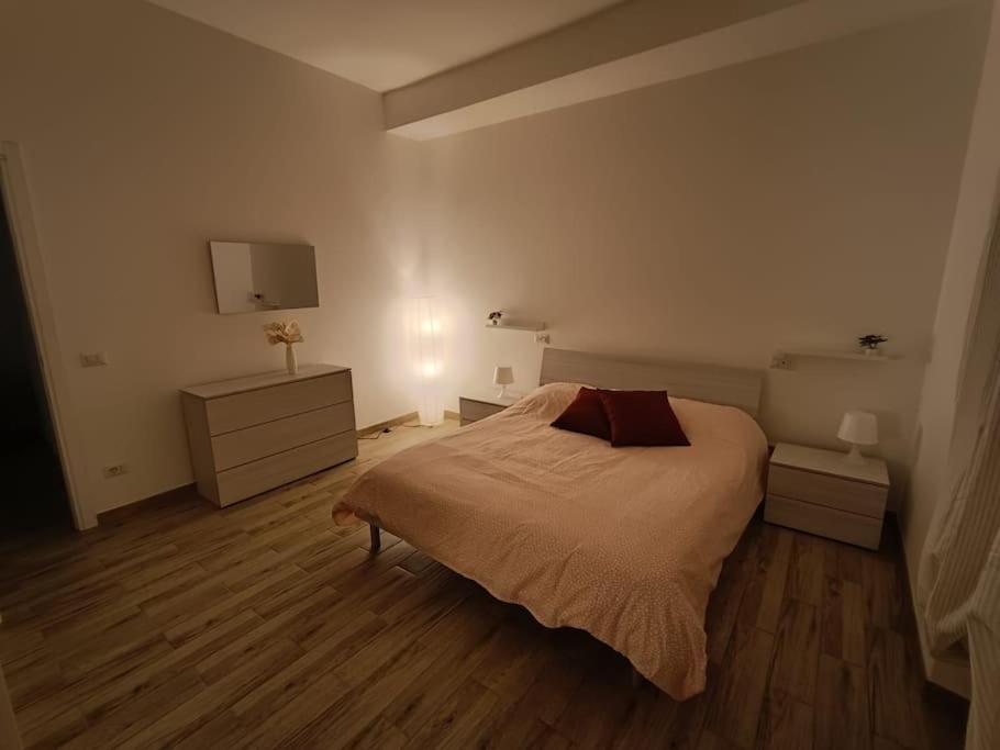 a bedroom with a bed and a dresser and a tv at Casa No-Vi in Rome