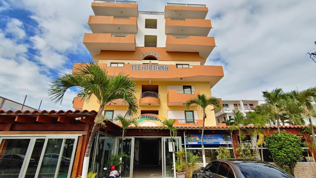 d’un bâtiment jaune avec un panneau indiquant la couleur dans l'établissement Residence Meridiana, à Juan Dolio