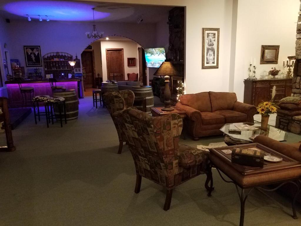 a living room with a couch and a table at Tuscan Manor in Eureka Springs