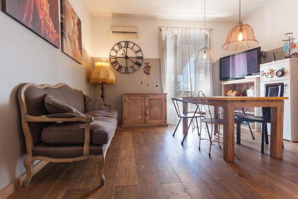 a living room with a table and a chair at Guest house Trevignano Romano in Trevignano Romano