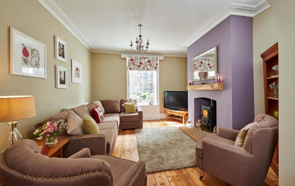 a living room with two couches and a fireplace at Harbour House in Whitby