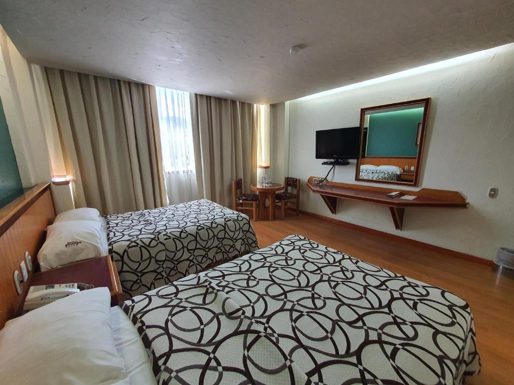 Postel nebo postele na pokoji v ubytování Hotel Alcampo