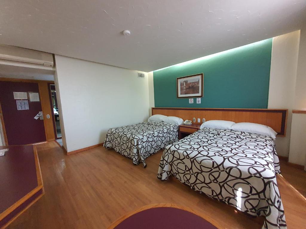 Postel nebo postele na pokoji v ubytování Hotel Alcampo