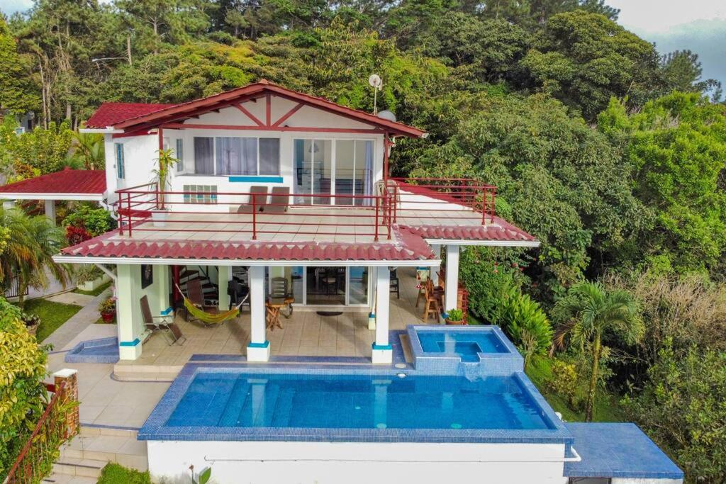 an aerial view of a house with a swimming pool at Villa La Vista of Panama City and magestical mountains from infinity pool in Cerro Azul