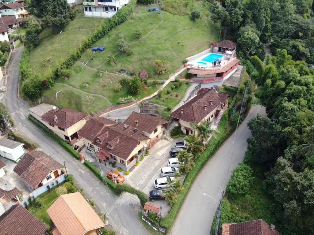 an aerial view of a house with a road and a yard at Pousada Cantinho da Paz in Itatiaia