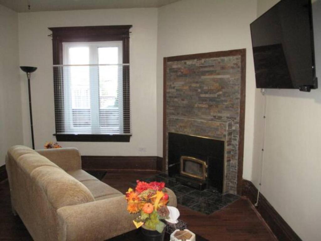 a living room with a couch and a fireplace at Wolseley the heart of the city ! in Winnipeg