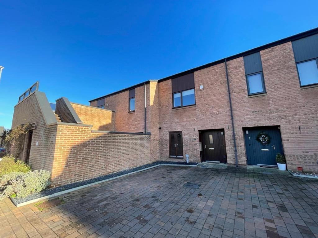 a brick building with a brick driveway in front of it at 2 Bedroom House with Garden Next to River Tees in Stockton-on-Tees