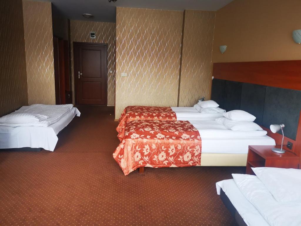 Postel nebo postele na pokoji v ubytování Hotel i Restauracja Bona