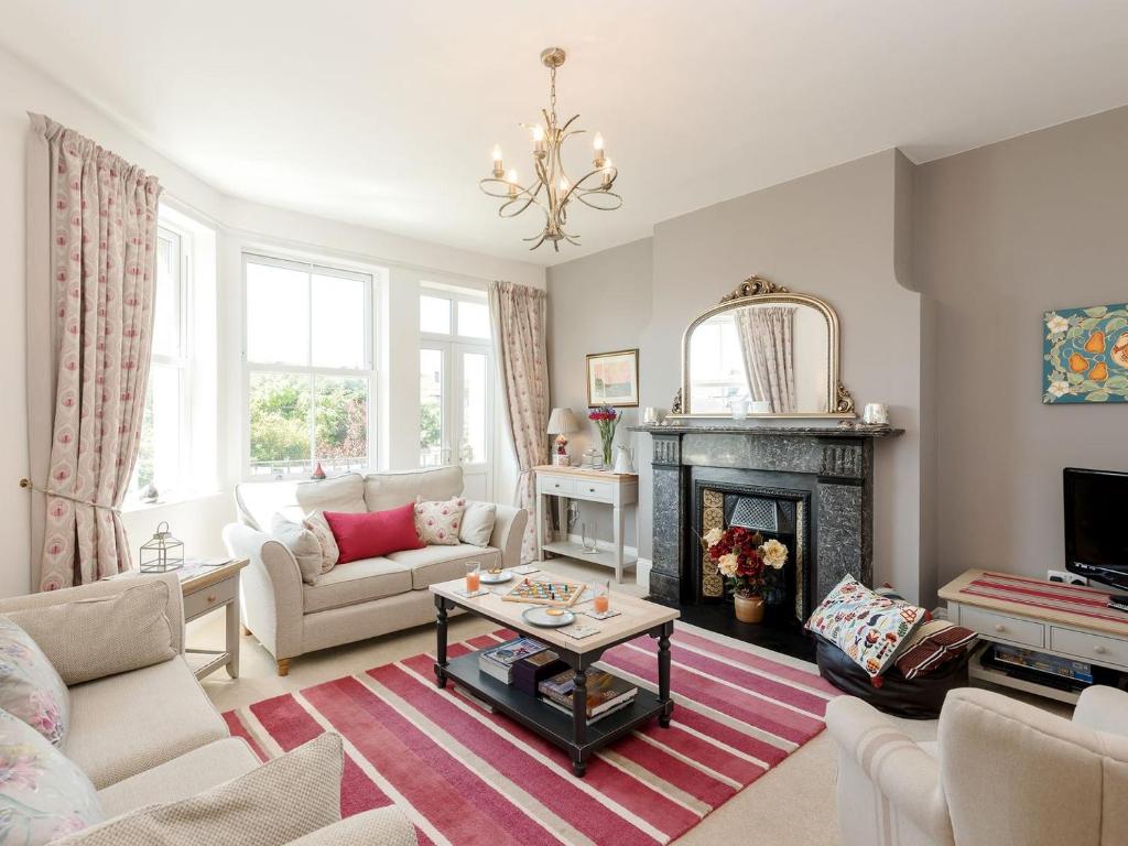 a living room with a couch and a fireplace at Moonbeam House in Freshwater