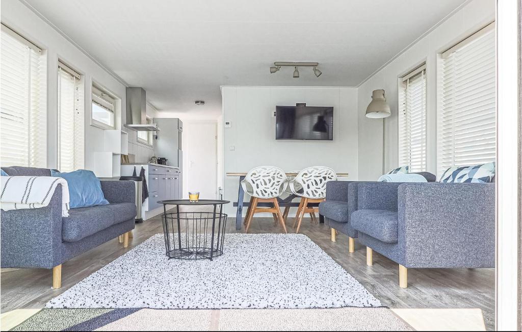 a living room with two blue couches and a table at AquaLiving in Leimuiden
