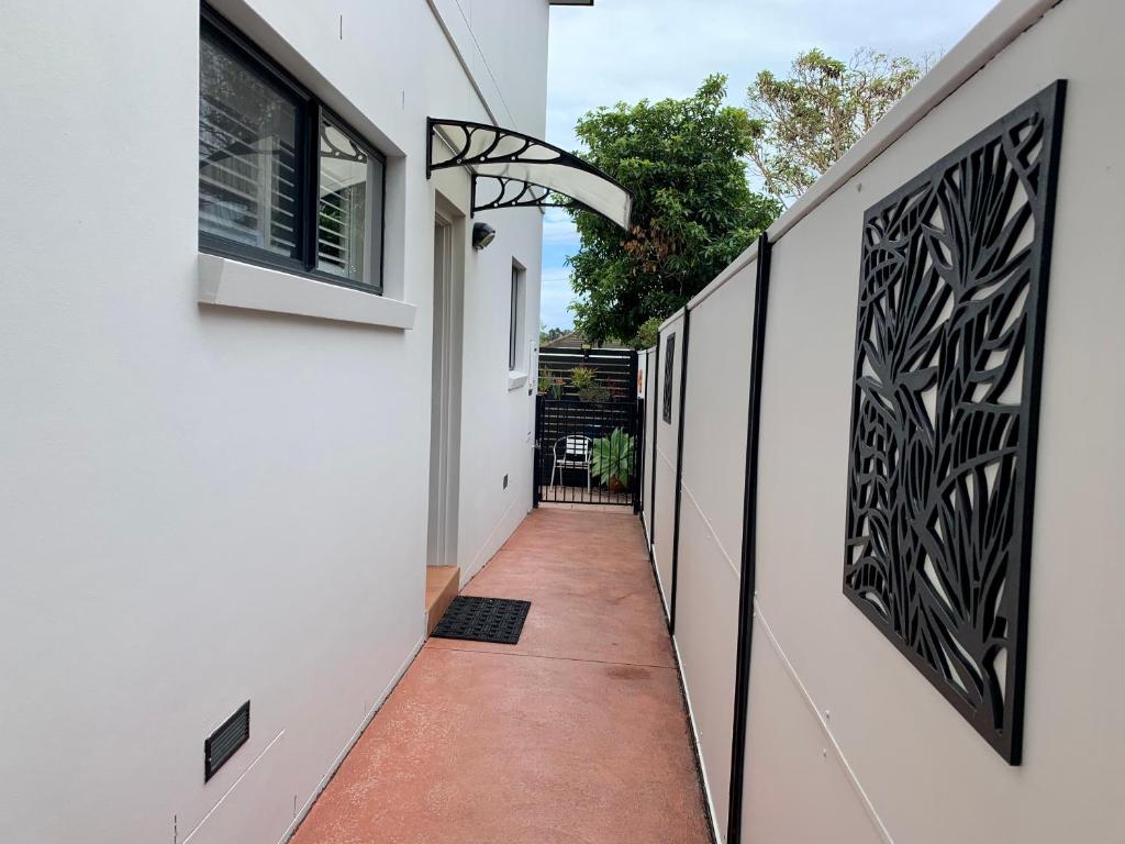 a hallway of a house with black and white walls at Pelicans Rest Shellharbour in Shellharbour
